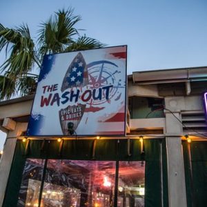 Enjoy food and drinks at The Washout Folly beach with scenic views of the water.